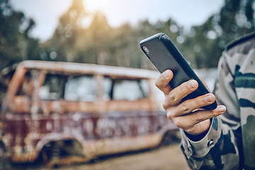 Image showing Smartphone in hand, communication and military person in paintball game outdoor, fitness and technology with mockup space. Chat, online and 5g network with social media, soldier in camouflage uniform