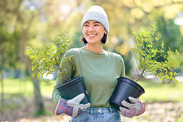 Image showing Plants, gardening and woman volunteering for agriculture, growth project and sustainability on earth day. Park, natural environment and community service worker, farmer or person with trees in forest