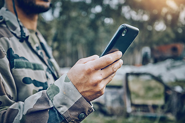 Image showing Military soldier, mobile phone and communication while outdoor for connection, safety and security. Army person with a smartphone for social media, contact or chat on a field, boot camp or at war