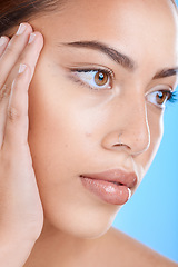 Image showing Skincare, face and woman in studio for beauty, wellness and cosmetics grooming on blue background. Skin, facial and girl model relax in luxury, collagen and dermatology, self care or hygiene isolated