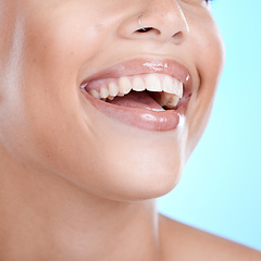 Image showing Teeth, dental and woman with face and smile, beauty and oral healthcare, clean mouth with fresh breath in studio. Veneers, orthodontics and lips with skin, glow and cosmetic care on blue background