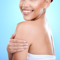 Image showing Body, skin and woman in studio for skincare, wellness and hygiene on blue background. Arm, profile and girl model relax for beauty, luxury and grooming with cosmetics, self love and cleaning isolated