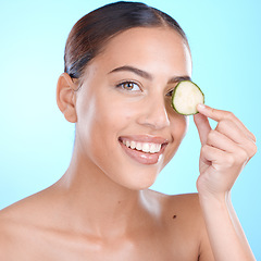 Image showing Skincare, cucumber and beauty portrait of woman about natural dermatology face cosmetics. Happy person with vegetable spa product for self care, skin glow and facial wellness on blue background