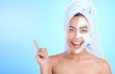 Image showing Beauty, face mask portrait and woman with mockup space for dermatology cosmetics. Excited person pointing hand at spa skincare product for self care, skin glow and facial wellness on blue background