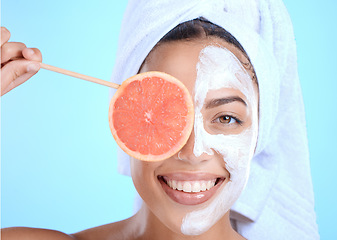 Image showing Skincare, portrait and woman with grapefruit mask in studio for beauty, hair and cosmetics on blue background, Face, facial and girl model relax in fruit, luxury and product, wellness or isolated