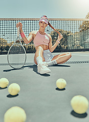 Image showing Portrait, tennis sports and woman on court with racket after workout, training or exercise. Fashion, fitness balls or female athlete sitting, resting or relax on stadium outdoors after match or game