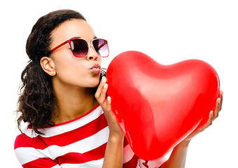 Image showing Heart, kiss and valentines day with a black woman in studio isolated on a white background for love or romance. Red, romantic and dating with a female holding an icon, symbol or emoji on blank space