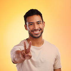Image showing Portrait, hands and man with peace sign in studio isolated on a yellow background. Face, fashion and hand gesture, v symbol or emoji of happy young male model in stylish, designer and cool clothing.