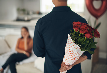 Image showing Man, hands and red roses behind back for valentines day surprise, gift or present to celebrate date at home. Hand of male with bouquet of flowers in celebration anniversary for special month of love