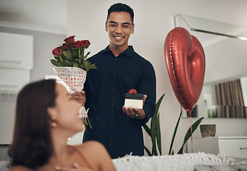 Image showing Surprise, love and man with a gift and roses for his wife for valentines day, romance or anniversary. Happy, romantic and husband with present and bouquet of flowers for his woman in the living room.