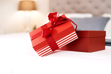 Image showing Present, love gift and bedroom with no people with celebration box for valentines day. Red gifts, presents and bed in a house with surprise, celebrating and birthday package with ribbon and zoom