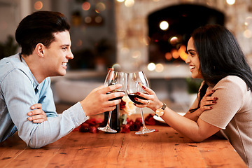 Image showing Love, wine and couple cheers on valentines day date at home with smile, romance and bokeh. Date night, man and woman at table in living room, valentine celebration and happy relationship together.