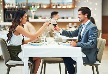 Image showing Love, wine and couple toast in restaurant for romantic dinner, honeymoon and anniversary celebration. Valentines day, fine dining and man and woman together for luxury date, alcohol drinks and relax