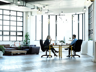 Image showing Business people, meeting and team in office for creative, planning and proposal discussion on window background. Businessman, partner and teamwork with woman colleague together for strategy or goal