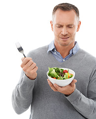 Image showing Diet, nutrition and unhappy man with salad and fork disappointed with healthy lunch or dinner in studio. Health, wellness and food, model with frown and nutritional meal isolated on white background.