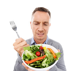 Image showing Man with salad, frown on face and vegetables, problem with healthy lifestyle and diet isolated on white background. Health, wellness and male with doubt about food choice, nutrition in studio