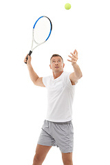 Image showing Tennis player, athlete and hitting a ball training, fitness and workout isolated against a studio white background. Man, sports and exercise as a hobby for health and person serve for a match