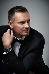 Image showing Success, handsome and mature man in tuxedo and serious and isolated on grey background in studio. Luxury, glamour and wealth with cool celebrity actor style, elegant and sexy date for valentines day.