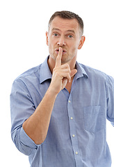 Image showing Hush, secret and portrait of a man in a studio with a silence, quiet or whisper face expression. Person, handsome and mature male model with a finger on his mouth gesture isolated by white background