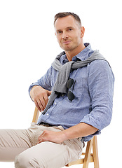 Image showing Portrait, fashion and man with style sitting on a chair and confident person isolated in a studio white background. Trendy, gentleman and guy or model looking handsome, stylish and well dressed