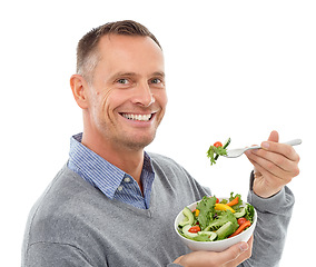 Image showing Portrait, food and salad with a man in studio isolated on a white background eating vegetables for health. Green, nutrition or diet with a happy mature male indoor to eat an organic meal for wellness