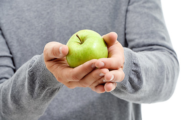 Image showing Hand, wellness and male in a studio with a apple for nutrition, diet and a healthy snack with vitamins. Health, natural and healthy man or person with fresh, organic and raw green fruit for a craving