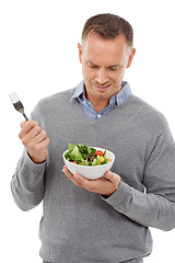 Image showing Man with salad, frown on face and vegetable, problem with healthy lifestyle and diet isolated on white background. Health, wellness and male with doubt about food choice, nutrition in studio