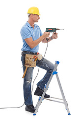 Image showing Happy, handyman and repairman in studio with a drill, tool belt and ladder for maintenance. Happy, smile and professional male industry worker with tools for repairs isolated by white background.