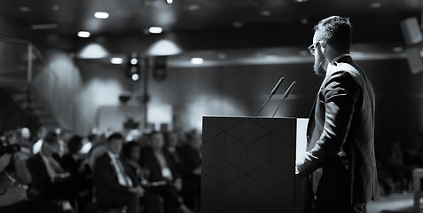 Image showing Speaker giving a talk on corporate business conference. Unrecognizable people in audience at conference hall. Business and Entrepreneurship event