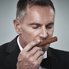 Image showing Luxury, vintage and man smell cigars for smoking habit on gray background for wealth, power and success. Mafia boss, business gangster and face of senior male smelling tobacco for rich lifestyle