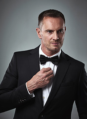 Image showing Studio portrait of mature man, tuxedo and handsome, serious and isolated on grey background. Luxury, glamour and wealth, success with celebrity actor style, elegant and date for valentines day.