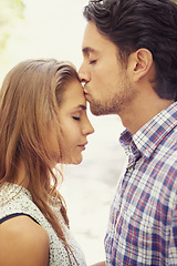 Image showing Kiss, affection and couple with love in nature on a date, bonding and loving in a relationship. Content, romance and man kissing a woman on the forehead during valentines day at a park in Italy