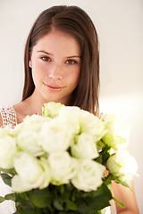 Image showing Portrait, woman or white roses for love, gift or smile for Valentines day, happiness or joy for floral present on studio background. Face, female or lady with flowers, bouquet or cheerful on backdrop