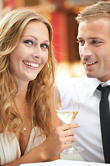 Image showing Love, couple and champagne for celebration, happiness and achievement outdoor, romance and joyful. Portrait, man and woman with alcohol, wine glass and Valentines day date, relationship and smile