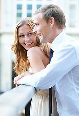 Image showing Love, romance and couple on bridge for valentines day celebration happy fun in the city. Embrace, man and woman with smile standing on balcony or terrace while on romantic valentine date together.