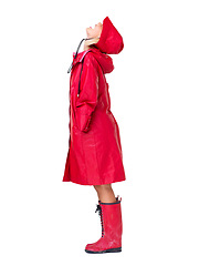 Image showing Fashion, red raincoat and woman on a white background with trendy, stylish and waterproof clothes in studio. Winter boots, rain weather and isolated full body of excited, happy and girl with smile