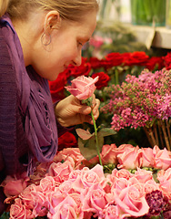 Image showing Woman, smelling roses and retail for floral bouquet for scent, color and shopping for valentines day gift. Flowers, leaves and sustainable plants for beauty, present and sale in startup florist store