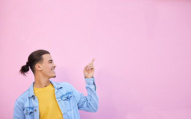 Image showing Happy, smile and man pointing in a studio with mockup space for advertising, marketing or product placement. Happiness, excited and male model showing mock up or copyspace isolated by pink background