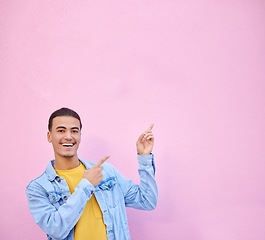 Image showing Man pointing, wall mockup space and smile for portrait with fashion, happy and excited face by backdrop. Gen z model, gesture and hands with happiness, mock up and student by urban pink background