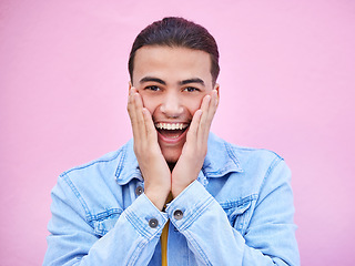 Image showing Man, hands and cheeks for surprise in portrait with happiness, excited and pink wall background. Happy gen z model, wow face and smile for announcement, fashion and news for career, success and goal