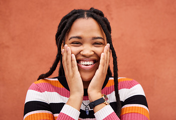 Image showing Excited black woman, hands and cheeks in portrait by city wall background with smile, happiness and beauty. Gen z student girl, young model and fashion in urban metro for adventure, happy and freedom