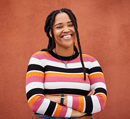 Image showing Happy, smile and portrait of a black woman by a wall in city while walking for adventure. Happiness, freedom and African female posing with crossed arms in a town on holiday, vacation or weekend trip