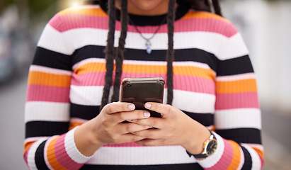 Image showing Closeup, hands and black woman with smartphone, city and typing for social media, connection and online reading for email. Zoom, female and African lady with cellphone, carefree and freedom in street