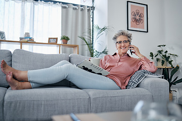 Image showing Senior woman, sofa and phone call in home living room with smile, relax and newspaper for happy portrait. Retirement, smartphone communication and elderly lady on lounge couch for smile, chat or talk