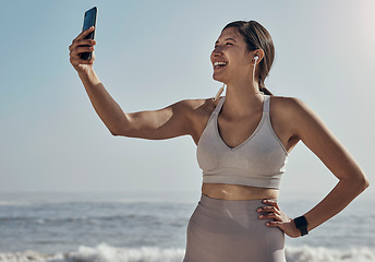 Image showing Fitness, selfie and woman at the beach for yoga, training and workout on blue sky background. Social media, live streaming and exercise influencer female recording for blog, post or profile picture