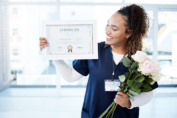 Image showing Certificate, flowers and a black woman graduate in the hospital feeling proud of her achievement. Smile, graduation and qualification with a happy young female nurse standing alone in a clinic