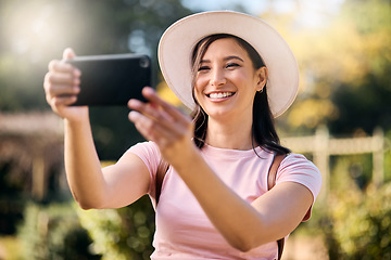 Image showing Woman on holiday, smartphone and travel with selfie and adventure outdoor, happy and freedom in nature. Influencer with blog, content creation and phone photography, smile in picture and lifestyle