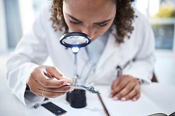Image showing Hand, microchip and magnifying glass with an engineer woman at work in a laboratory for research or innovation. Science, computer chip or zoom with a female scientist in a lab to develop electronics