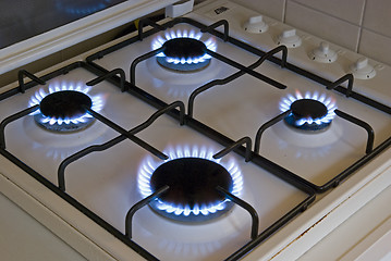 Image showing Four blue flames of a gas stove