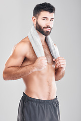 Image showing Health, fitness and body portrait of man with towel on neck, sports workout and hygiene isolated on grey background. Sweat, confidence and male model smile, self care mindset for exercise in studio.